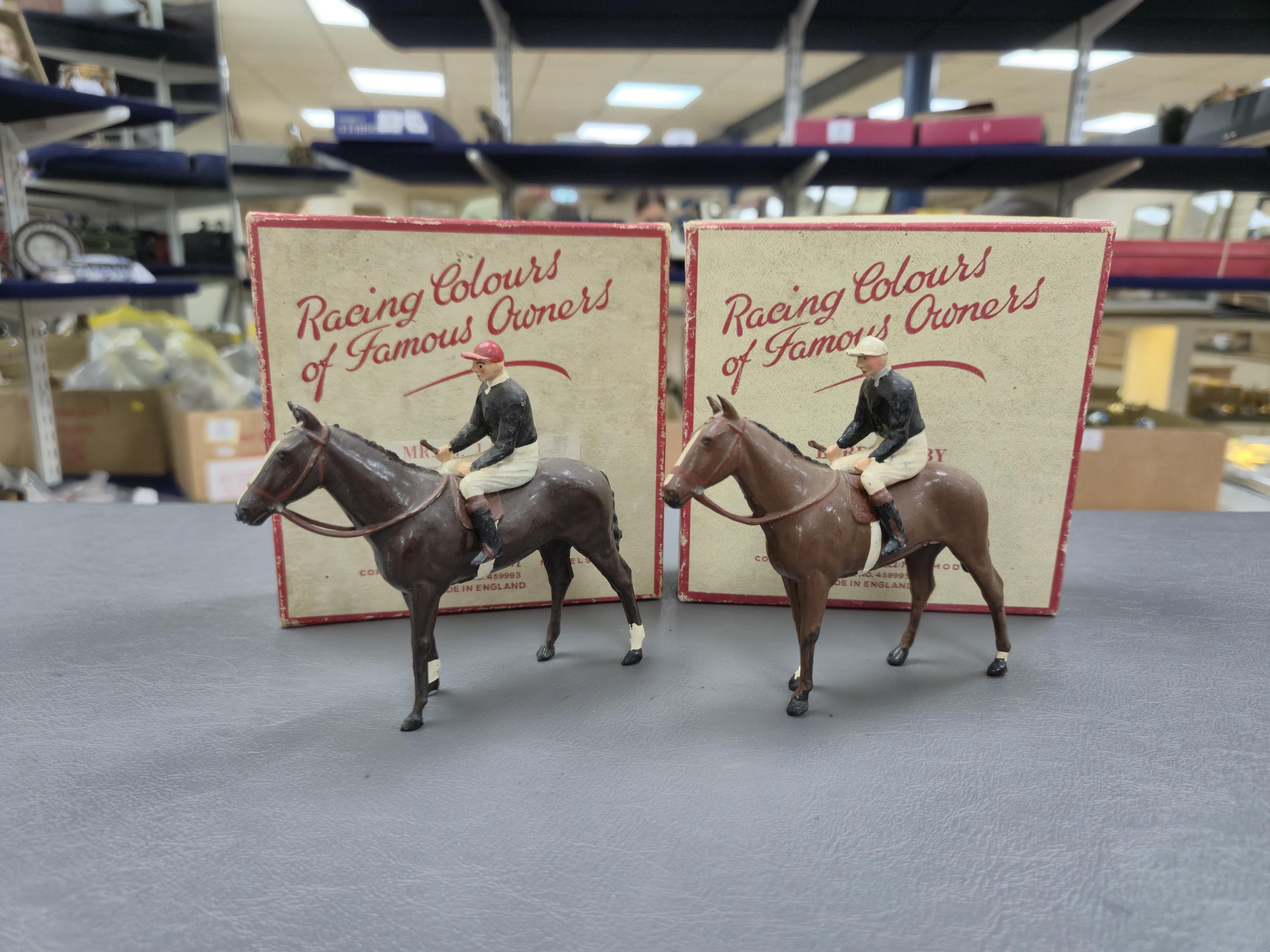 Two boxed Britains Racing Colours of Famous Owners series lead mounted figures; Lord Derby - rider in black jersey with a white cap on a brown horse, and Mr. H. J. Joel - rider in black jersey with red cap on a dark brow